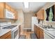 Efficient kitchen with light wood cabinets, white appliances, and ample counter space for meal preparation at 4326 Megan Manor Sw Dr, Powder Springs, GA 30127