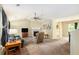 Cozy living room with a fireplace, vaulted ceiling, and neutral carpet, creating a welcoming atmosphere at 4326 Megan Manor Sw Dr, Powder Springs, GA 30127