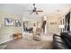 Spacious living area that connects the dining area and staircase, featuring a comfortable leather recliner at 4326 Megan Manor Sw Dr, Powder Springs, GA 30127