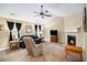 Inviting living room with a fireplace and ceiling fan, perfect for relaxation and entertainment at 4326 Megan Manor Sw Dr, Powder Springs, GA 30127