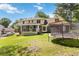 Backyard with an expansive lawn, screened porch, patio, and trampoline at 5152 Clearwater Dr, Stone Mountain, GA 30087