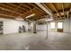 Spacious unfinished basement featuring concrete floors, exposed ceiling, and utilities at 5152 Clearwater Dr, Stone Mountain, GA 30087