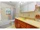 Bathroom featuring a bathtub, yellow countertop, and cabinet space at 5152 Clearwater Dr, Stone Mountain, GA 30087