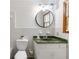 Bathroom with a toilet, white vanity, and green marble countertop at 5152 Clearwater Dr, Stone Mountain, GA 30087