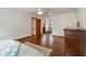 Spacious bedroom with wood floors, ceiling fan, adjoining rooms, and natural light at 5152 Clearwater Dr, Stone Mountain, GA 30087