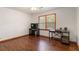 Bedroom featuring hardwood floors, a ceiling fan, and a desk at 5152 Clearwater Dr, Stone Mountain, GA 30087