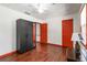 Bedroom with hardwood floors, ceiling fan, and black wardrobe closet at 5152 Clearwater Dr, Stone Mountain, GA 30087