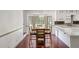 Dining room adjacent to kitchen includes a bay window and wooden dining set at 5152 Clearwater Dr, Stone Mountain, GA 30087