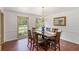 Bright dining room featuring a chandelier and wooden dining set with a view to the outdoors at 5152 Clearwater Dr, Stone Mountain, GA 30087