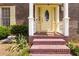 Close-up of a front door with sidelights, brick steps, and manicured landscaping at 5152 Clearwater Dr, Stone Mountain, GA 30087