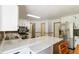 Well-lit kitchen with white cabinetry, stainless steel appliances, and a kitchen island at 5152 Clearwater Dr, Stone Mountain, GA 30087