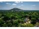 Breathtaking aerial view showcasing Stone Mountain peaking over the treetops and downtown homes in landscape at 1115 Third St, Stone Mountain, GA 30083