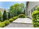 Paved backyard patio with lush landscaping and an outdoor living space at 1115 Third St, Stone Mountain, GA 30083