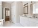 Bright bathroom with a double vanity, white cabinets, and large mirrors at 1115 Third St, Stone Mountain, GA 30083