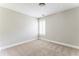 Carpeted bedroom with neutral walls, bright window, and white trim at 1115 Third St, Stone Mountain, GA 30083