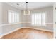 Charming dining room featuring wood floors, plantation shutters and neutral paint at 1115 Third St, Stone Mountain, GA 30083