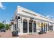 Charming two-story white brick building with dark door frames and beautifully arched windows and walkway at 1115 Third St, Stone Mountain, GA 30083