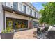 Side view of attractive white two-story business with a paved entrance and yellow patio furniture in front at 1115 Third St, Stone Mountain, GA 30083