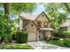 Two story home with stone accents and green foliage in the front yard at 1115 Third St, Stone Mountain, GA 30083