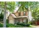 Charming two-story home with a stone-accented garage and a beautifully landscaped front yard at 1115 Third St, Stone Mountain, GA 30083