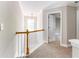 Bright hallway with neutral paint, decorative light fixture, and doorway to a bedroom at 1115 Third St, Stone Mountain, GA 30083