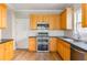 Kitchen featuring natural wood cabinetry, stainless steel appliances, and countertop at 1115 Third St, Stone Mountain, GA 30083