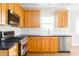 Modern kitchen with stainless steel appliances, ample wood cabinetry, and sleek countertops at 1115 Third St, Stone Mountain, GA 30083