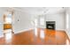 Spacious living room with gleaming hardwood floors, a fireplace, and bright, shuttered windows at 1115 Third St, Stone Mountain, GA 30083