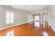 Hardwood floors in large living room with white trim and a view into the dining area at 1115 Third St, Stone Mountain, GA 30083