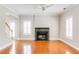Sunlit living room featuring a fireplace, hardwood floors, white trim and white shutters at 1115 Third St, Stone Mountain, GA 30083