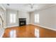 Spacious living room features hardwood floors, a fireplace and white shutters on the windows at 1115 Third St, Stone Mountain, GA 30083