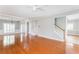 Sunlit living room features hardwood floors, high ceilings, white trim and an entry to the stairwell at 1115 Third St, Stone Mountain, GA 30083