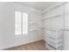 Well-organized walk-in closet with custom shelving and storage drawers and a window for natural light at 1115 Third St, Stone Mountain, GA 30083