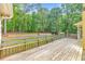 A backyard wood deck with railing overlooking a grassy area and trees at 115 Eagle Ridge Dr, Canton, GA 30114