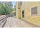 A backyard deck overlooks a grassy area and lush trees on a sunny day at 115 Eagle Ridge Dr, Canton, GA 30114