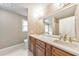 Bathroom with double sinks, granite counters, a large mirror and views into another bathroom and plenty of natural light at 115 Eagle Ridge Dr, Canton, GA 30114