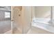 Bathroom with tub, stand-up shower and doorway to the main bedroom, showcasing a bright and functional design at 115 Eagle Ridge Dr, Canton, GA 30114
