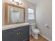 Bathroom featuring modern vanity with framed mirror, toilet, and wood-look flooring at 115 Eagle Ridge Dr, Canton, GA 30114