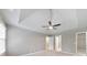 Neutral bedroom with plush carpeting, a modern ceiling fan, natural light and views of the closet and entry to another room at 115 Eagle Ridge Dr, Canton, GA 30114
