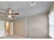 Bedroom features neutral walls, plush carpeting, a ceiling fan, a doorway, and windows with natural light at 115 Eagle Ridge Dr, Canton, GA 30114