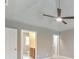 Neutral bedroom with plush carpeting and a modern ceiling fan with views into the bathroom and a doorway to another room at 115 Eagle Ridge Dr, Canton, GA 30114