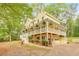 Inviting two-story home with a wide porch, garage, and manicured landscaping, showcasing its curb appeal at 115 Eagle Ridge Dr, Canton, GA 30114
