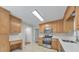 Kitchen with sleek stainless steel appliances, bright countertops, and light wood cabinetry at 115 Eagle Ridge Dr, Canton, GA 30114