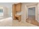Charming kitchen with light wood cabinetry and a built-in desk area, connected to a bright breakfast nook at 115 Eagle Ridge Dr, Canton, GA 30114