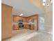 Charming kitchen features stainless steel appliances, light wood cabinets, and tile flooring at 115 Eagle Ridge Dr, Canton, GA 30114