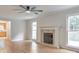 Bright living room featuring hardwood floors, fireplace, and large windows offering natural light at 115 Eagle Ridge Dr, Canton, GA 30114