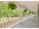 Relaxing porch with plants and white railings offering serene views of the surrounding greenery at 115 Eagle Ridge Dr, Canton, GA 30114