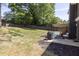 View of the backyard with a patio, grill, and a spacious lawn area at 2991 Windfield Cir, Tucker, GA 30084