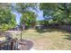 A spacious backyard with a wooden fence, green grass, and a wooden pergola at 2991 Windfield Cir, Tucker, GA 30084
