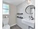 Modern bathroom featuring a sleek vanity, decorative shelving, and stylish mirror at 2991 Windfield Cir, Tucker, GA 30084